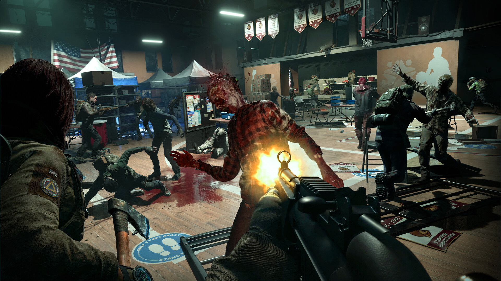 A team fighting a zombie wave inside a gym